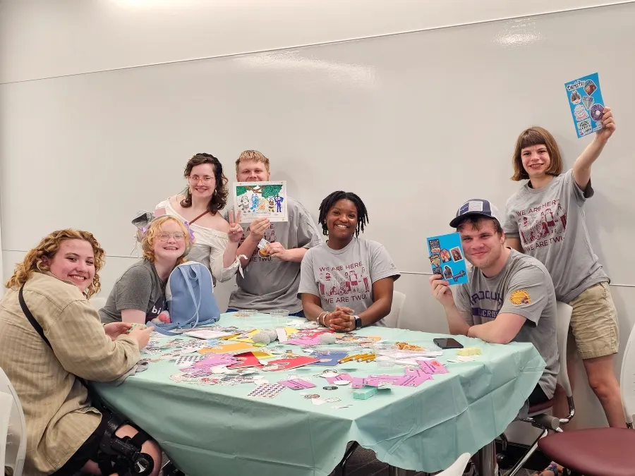Students smile around table
