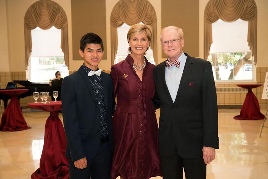 Chancellor Feyten and her husband Chad Wick pose together with a young man