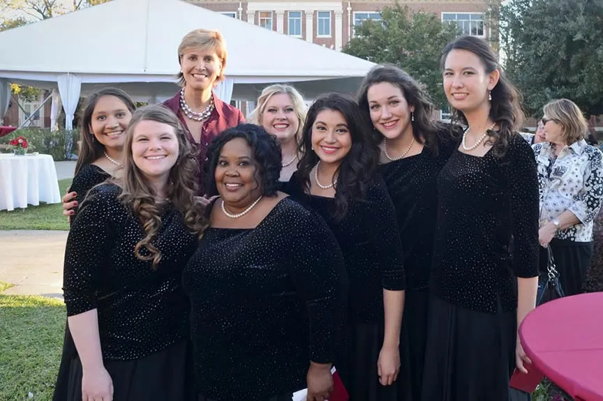 Chancellor Feyten stands with a group of TWU vocal performers