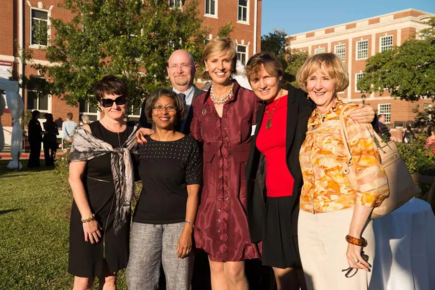 Chancellor Feyten poses for a photo with five people