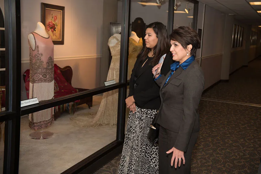 two women looking at the Texas First Ladies' Historic Costume Collection