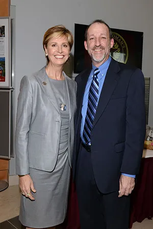 Chancellor Feyten poses with a man in a blue suit and tie