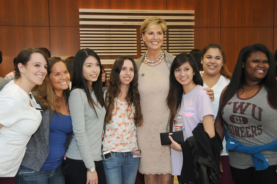 Chancellor Feyten poses with a group of students