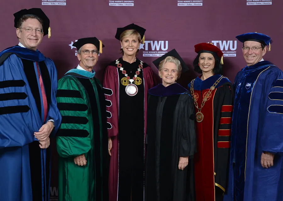 Chancellor Feyten poses for a group photo with officials from visiting universities