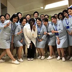 A group of young women wearing lab coats in a hospital setting