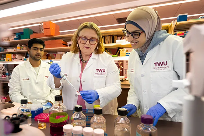 TWU international students perform research in a lab with a faculty mentor