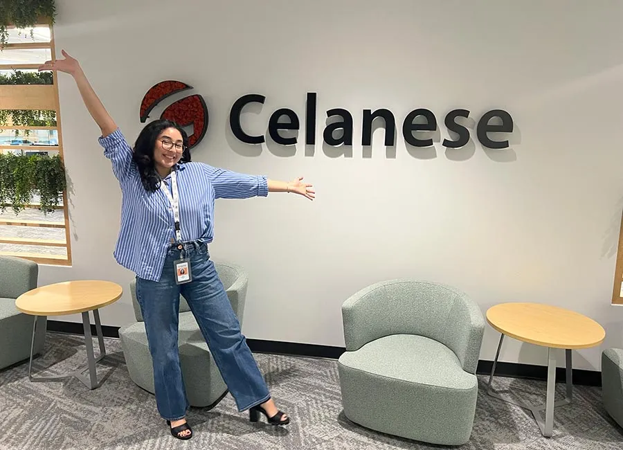Helen Velazquez in front of the Celanese logo