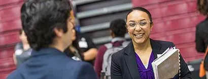 A TWU student talks with an employer at an internship and career fair.