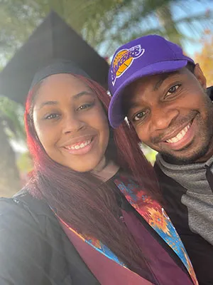 Kwashae Ruffin in her graduate cap and gown with her husband.
