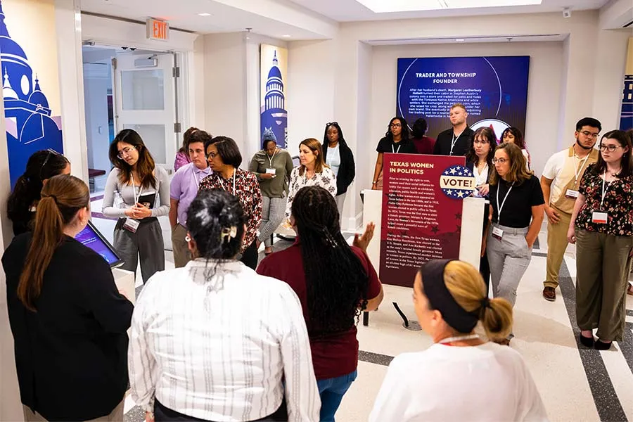 A crowd of people attending the unveiling of the redesigned exhibit at the Sue S. Bancroft Leadership Hall