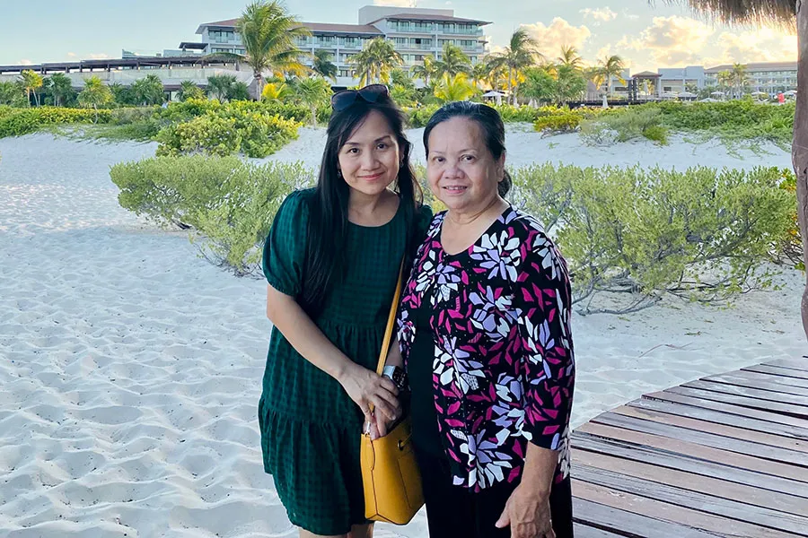 Thuy-Tien Ho stands next to her mother on beach