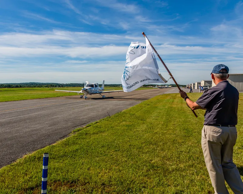 Air plane on runway with flag waving