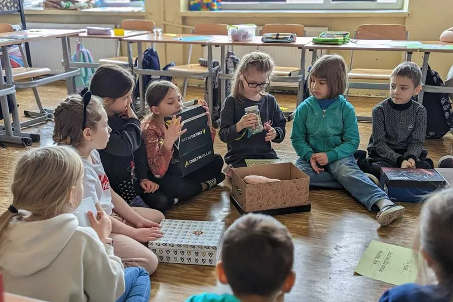 Ukrainian refugee students work on a project