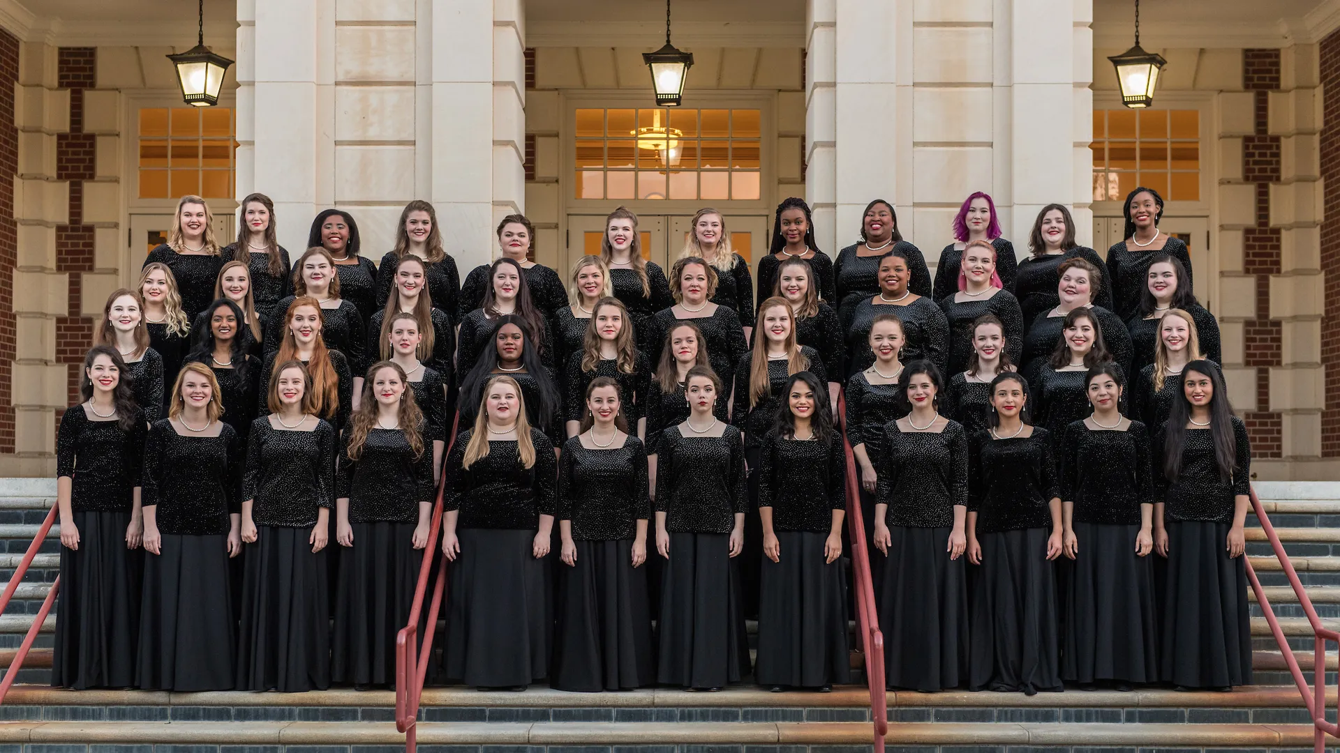 TWU choir posing for a group photo in front of the music building steps