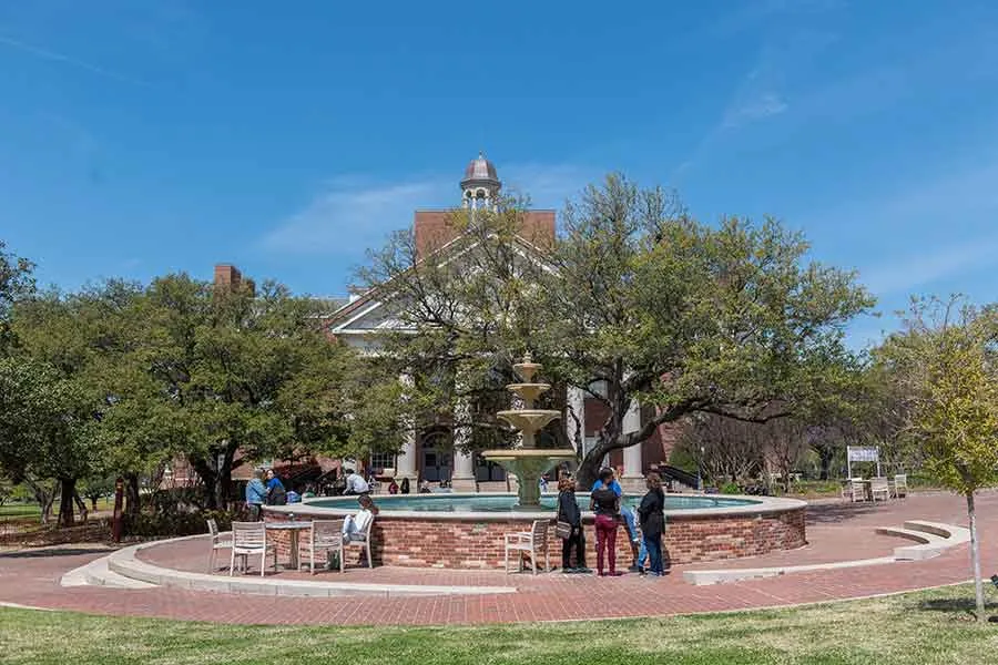Students relax around the fountain on TWU's Denton campus. 