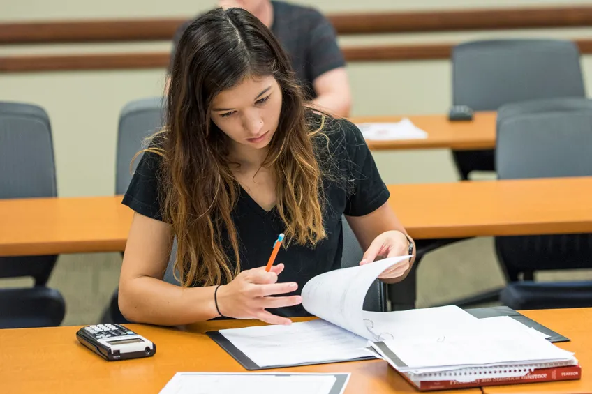 An undergraduate TWU mathematics student works on a probability and statistics assignment. 