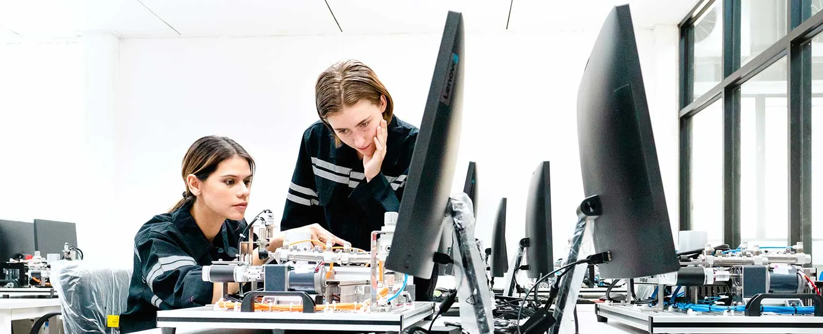 Two students work on a robotics project together