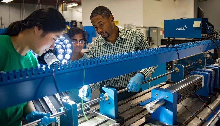 Engineering students work with equipment 