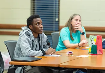 Two students at their desks in class