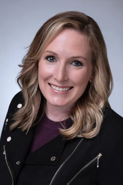 Erika in a purple shirt and black jacket