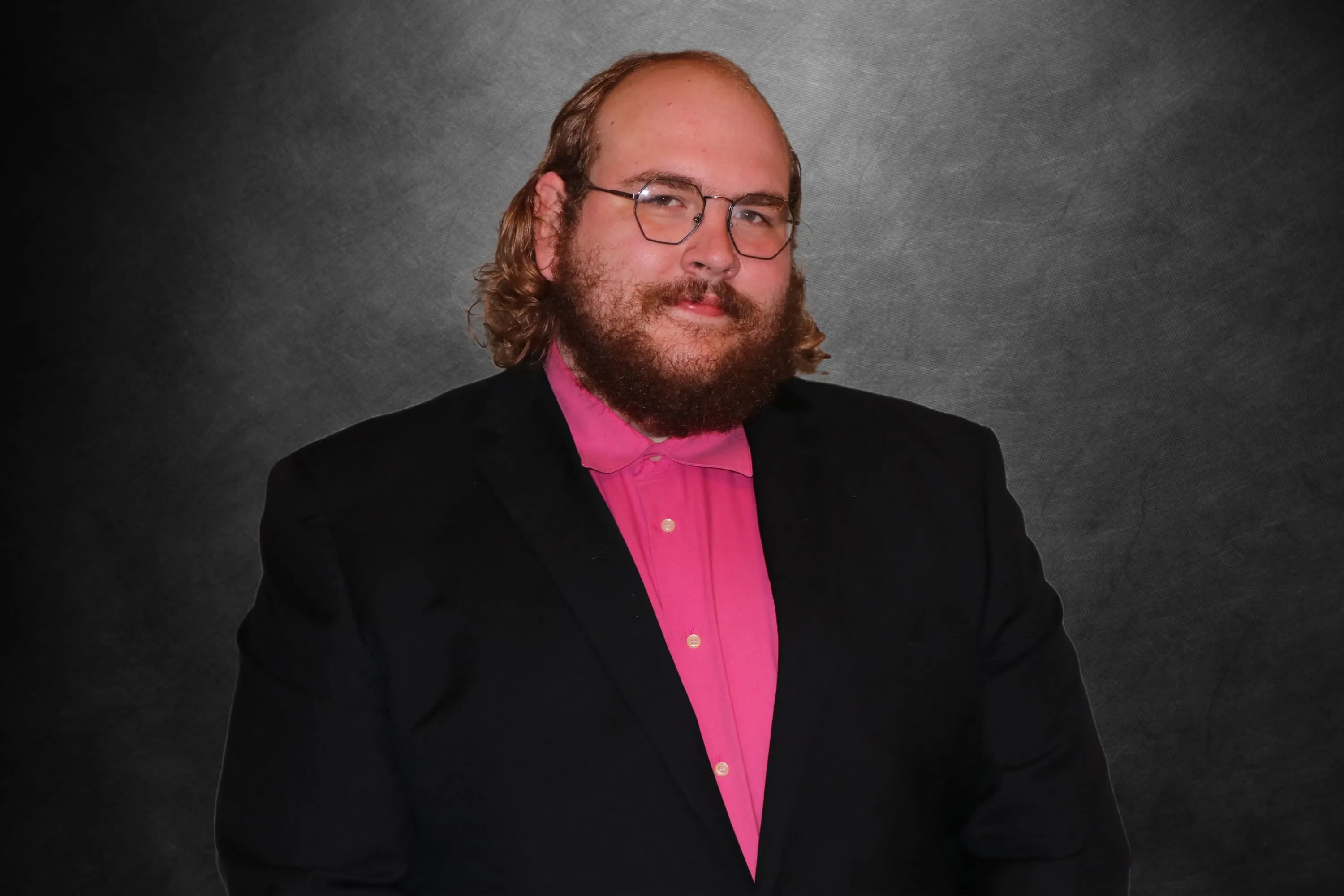 Andrew in a pink shirt and blazer