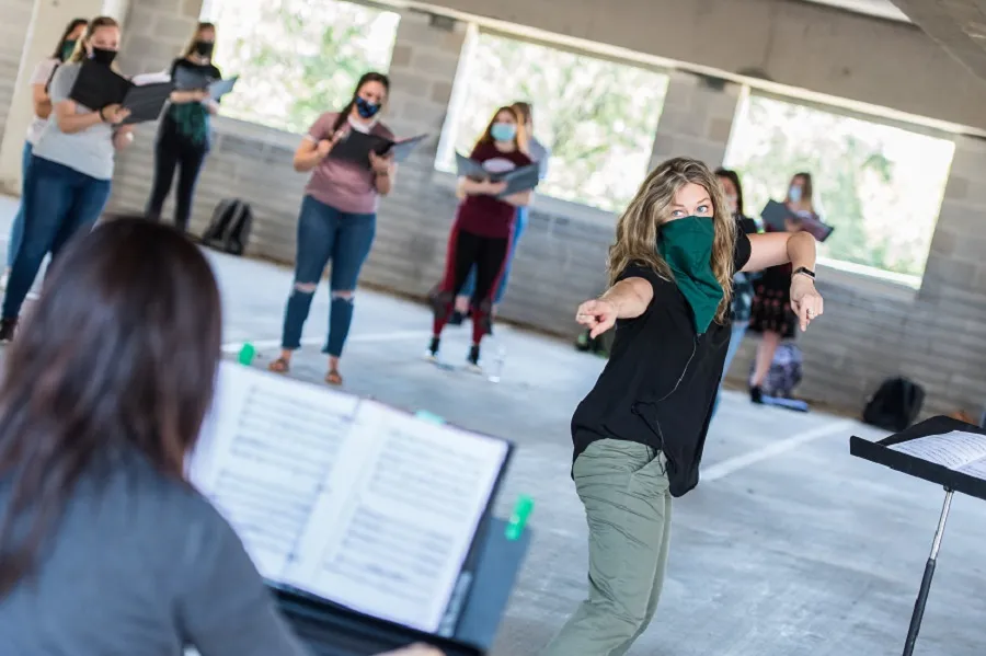 Joni Jensen rehearses with the TWU Concert Choir in the parking garage