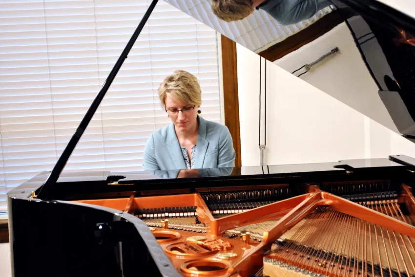 A TWU music student plays a piano 