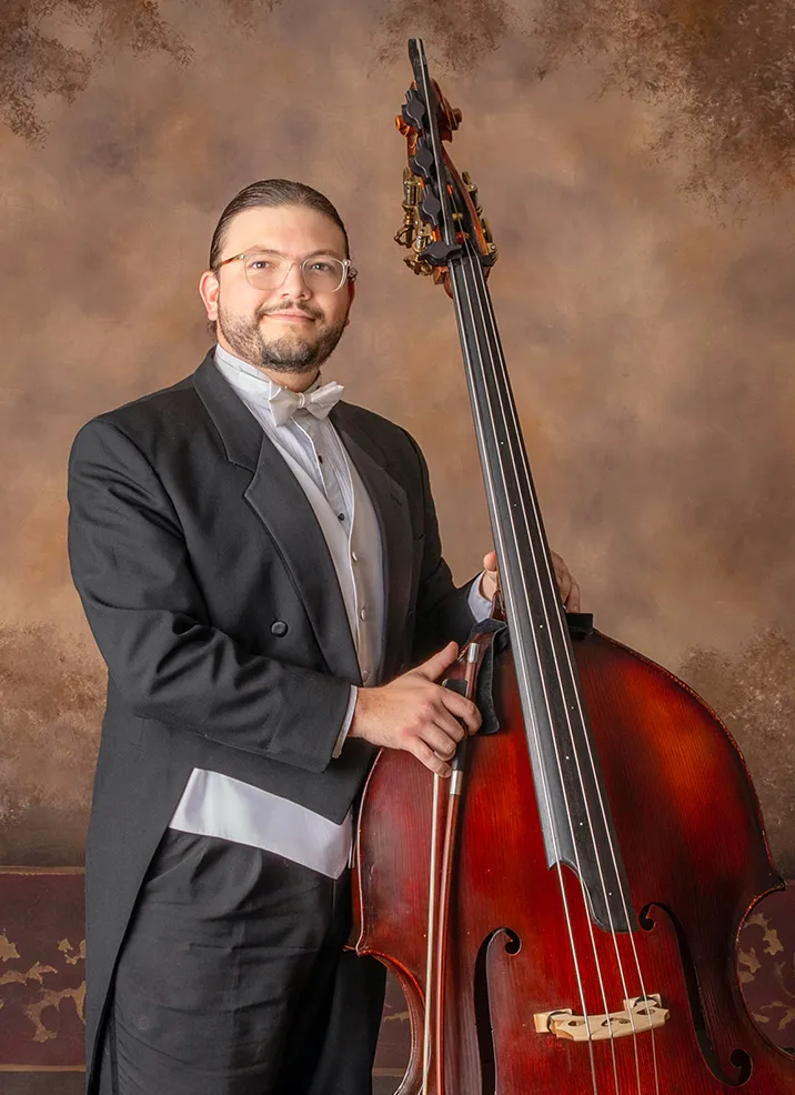 Jose holding a double bass