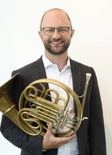 Ben Carroll holding a french horn