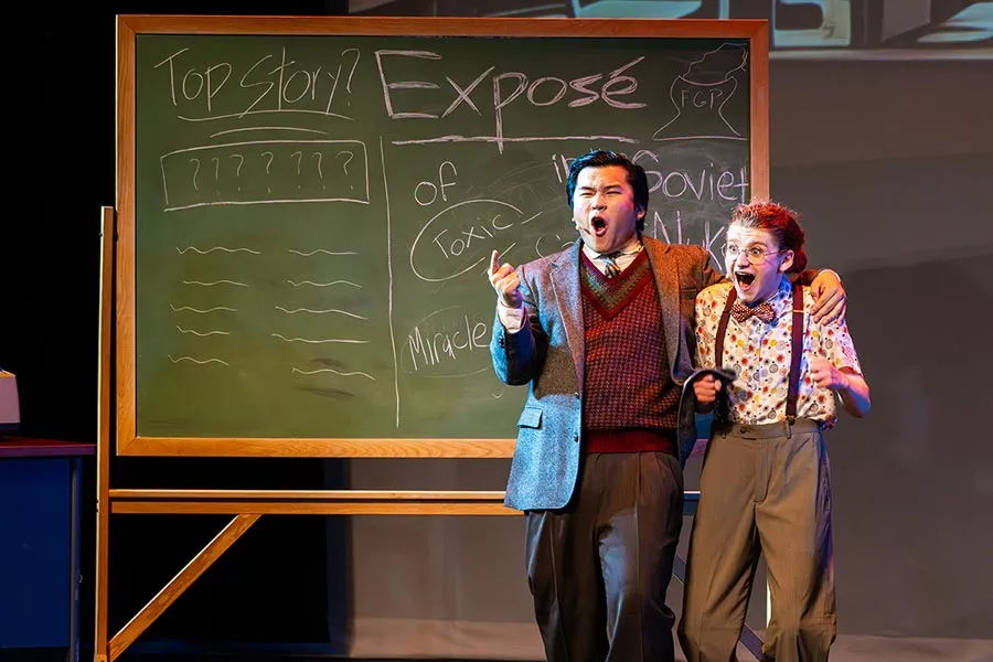 TWU musical theatre students perform on stage in front of a large chalkboard