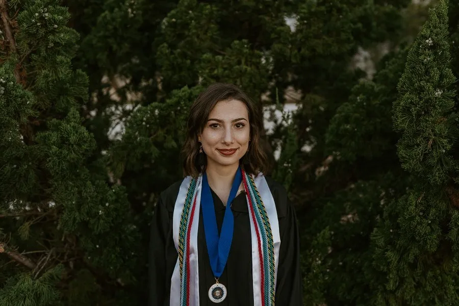 A headshot of Morgan Villavaso in a graduation cap and gown. 