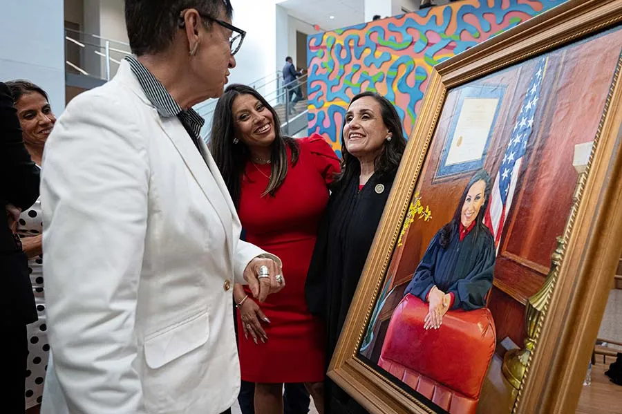 Judge Alia Moses smiles with family members