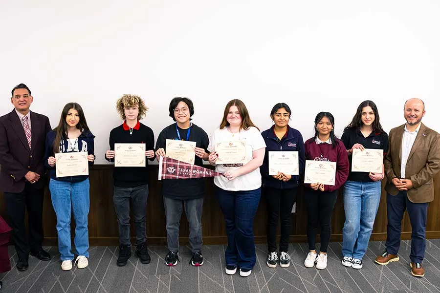 A group of students holding certificates