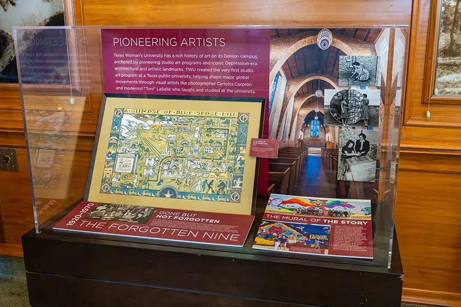 TWU State Fair exhibit cabinet featuring the university's art programs and campus landmarks