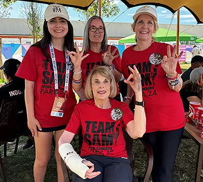 Members of the Watson family wearing matching Team Sam t-shirts all make the TWU hand sign