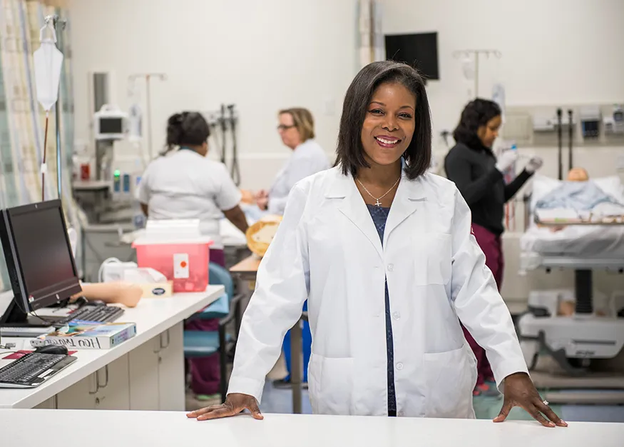 nurse educator smiling in lab coat