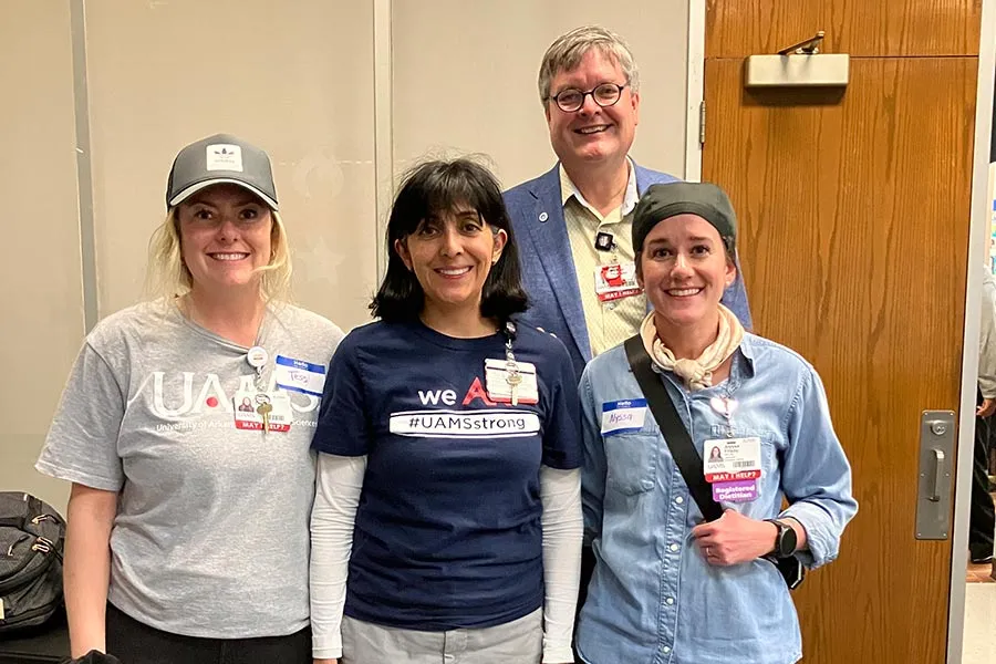 Stephanie Lopez-Neyman, wearing a blue shirt, stands with three of her colleagues