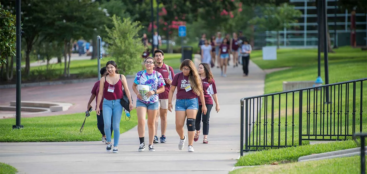 A group of TWU students at orientation walk across the Denton campus.