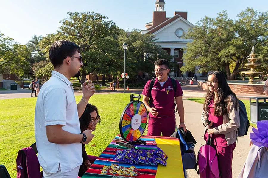TWU students spin the wheel for Pachanga prizes