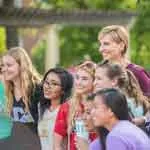 Chancellor Feyten with several TWU students on the Denton campus.