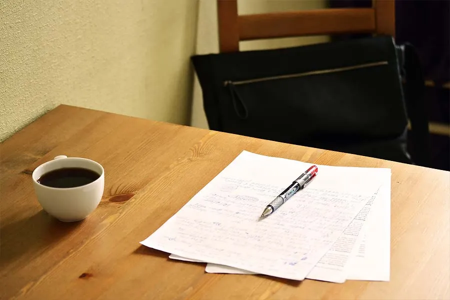 Papers, pen, and coffee mug on a desk