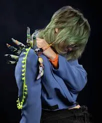 Woman with denim jacket with fabric spikes along back and shoulders