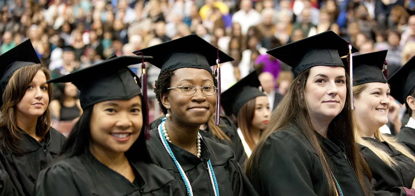 Close up shot of 5 graduates at commencement