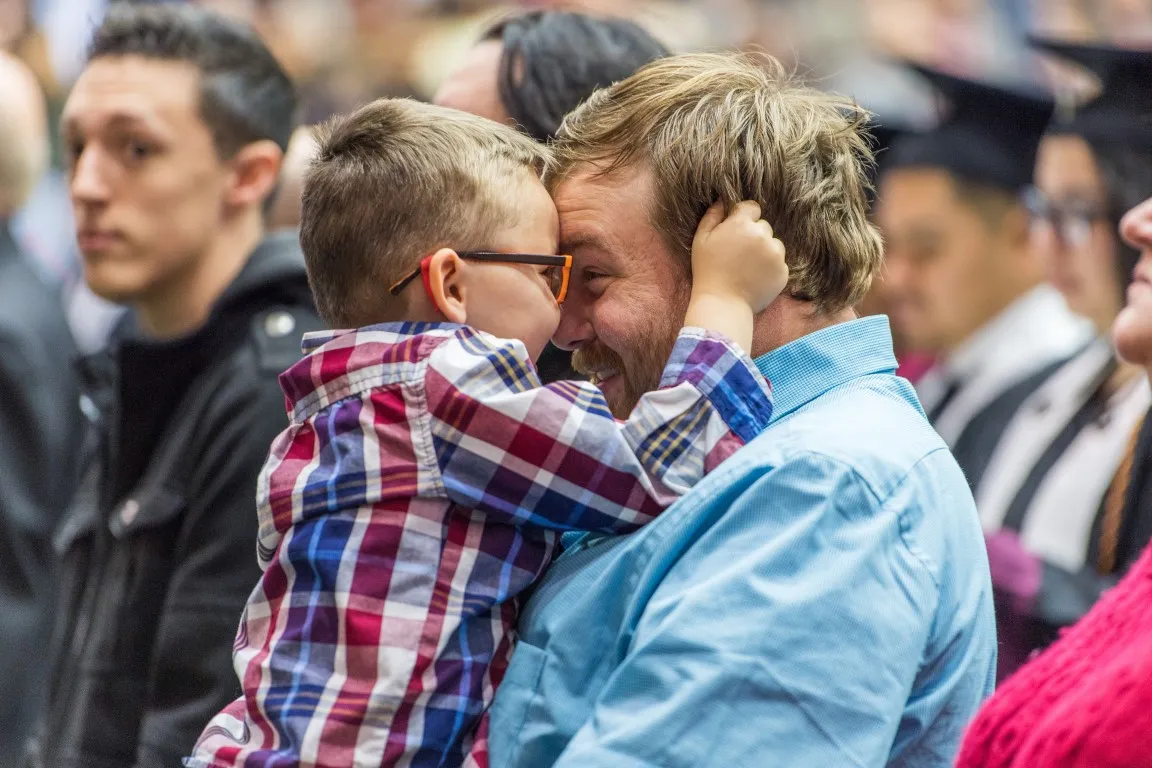 Parent and child facing each other at TWU commencement