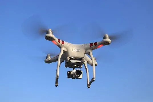 Drone flying in blue sky