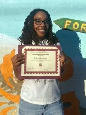 Norman displays her Continuing Education Award