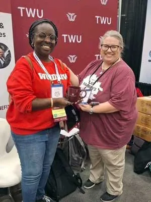 Fun at the SLIS booth at TLA 2025