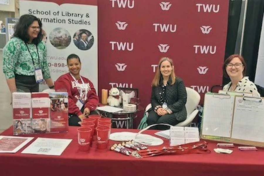 SLIS staff work TLA 2025 booth