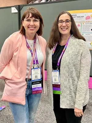 Hoffman poses with poster presenter at TLA