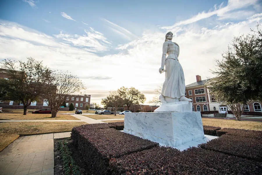 TWU's Minerva statue, pictured in front of the Ann Stuart Science Complex at sunrise.